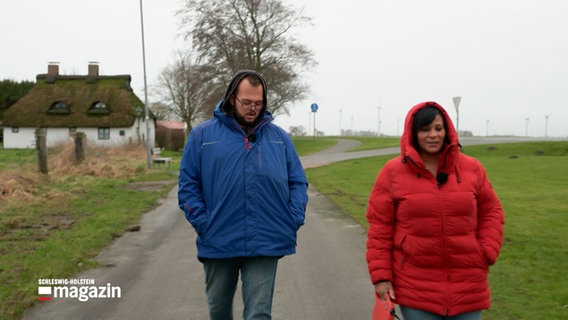 Mutter und Sohn gehen mit einem Hund spazieren. © NDR 