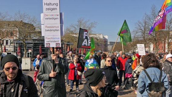 Menschen mit Flaggen und Bannern demonstrieren in Neumünster gegen Rechts. © Daniel Friederichs Foto: Daniel Friederichs