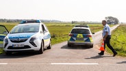 Ein Polizist sperrt mit einem Verkehrshütchen die Straße ab. © dpa-Bildfunk Foto: Benjamin Nolte