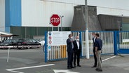 Eine Gruppe von Männern unterhält sich vor dem Gebäude der Nobiskrug GmbH © NDR Foto: Christian Wolf