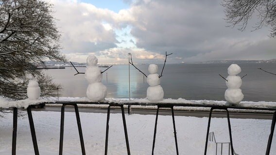 Kleine Schneemänner auf einem Geländer. © Gerlinde Malessa Foto: Gerlinde Malessa
