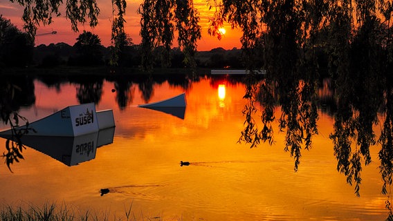Farbenfroher Sonnenuntergang am Rumpelsee bei Süsel. © Hans-Otto Klies Foto: Hans-Otto Klies