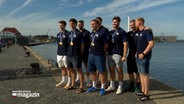 Spieler des Handballvereins "SH Flensburg-Handewitt" präsentieren am Flensburger Hafen ihre olympischen Medaillen © NDR Foto: NDR Screenshot