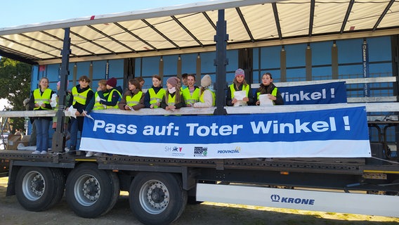 Ein Poster "Pass auf: Toter Winkel" hängt an einem Anhänger. © Anne Lemo Foto: Anne Lemo