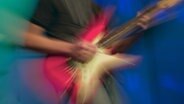 Das Pictogramm eines E-Gitarristen © dpa-bildfunk Foto: dpa-bildfunk