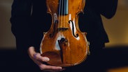 Eine Geige in der Hand © NDR/Jewgeni Roppel Foto: Jewgeni Roppel