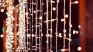 Verschiedene leuchtende Lichterketten hängen nebeneinander. © Colourbox Foto: ponsulak