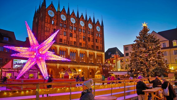 Eisbahn und beleuchtetes Rathaus auf dem Weihnachtsmarkt von Stralsund © Basic Events Foto: Rene Becker