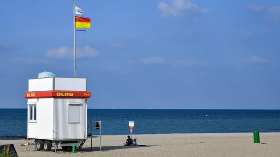 Eine rot-gelbe Flagge weht an einem DLRG-Wachhaus in Niendorf an der Ostsee. © picture alliance/Bildagentur online Foto: Ohde