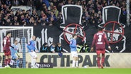 Kiel-Anhänger mit einer Choreografie, in der Fadenkreuze über die Konterfei mehreren Personen wie von z.B. Jürgen Klopp (r.) gesetzt wurden. © IMAGO / Susanne Hübner 