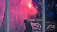 Hansa-Fans zünden Pyrotechnik während des Zweitliga-Sopiels beim SC Paderborn. © IMAGO / Ulrich Hufnagel 