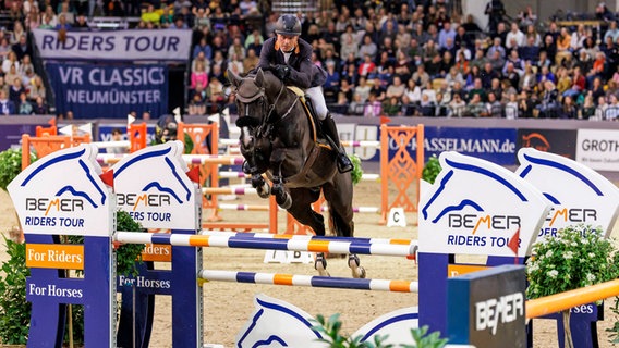 Philip Rüping überwindet mit Baloutaire ein Hindernis bei den VR Classics in Neumünster. © IMAGO / Stefan Lafrentz 